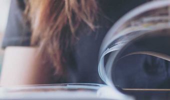 Woman flipping through a magazine.