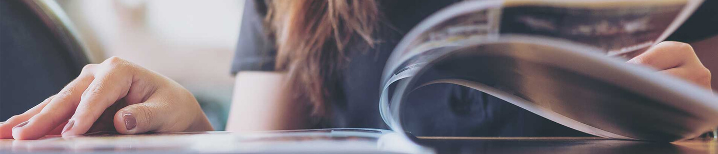 Woman flipping through a magazine.