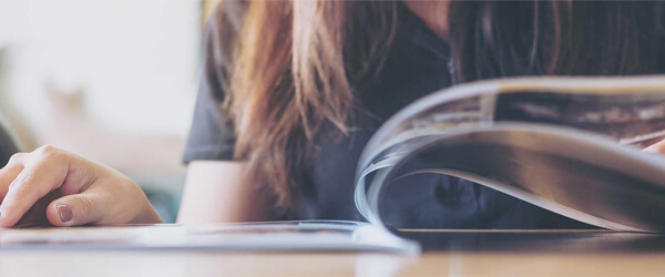 Woman flipping through a magazine.